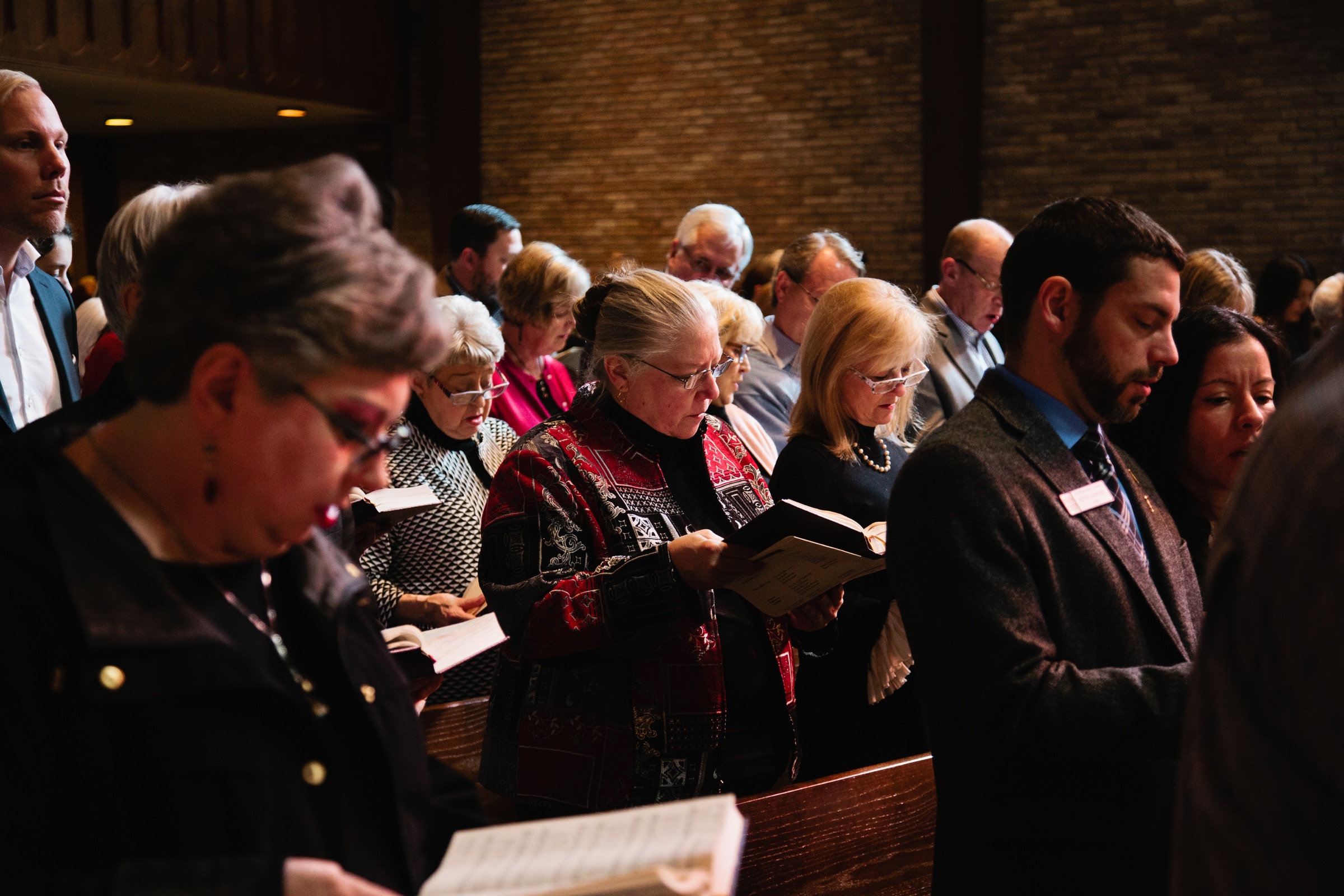 Congregation singing from hymnals during worship.